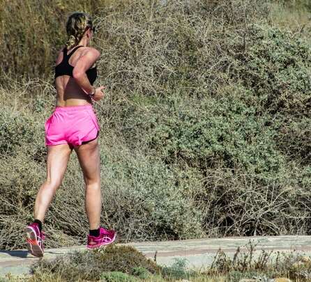 woman running outside on a trail