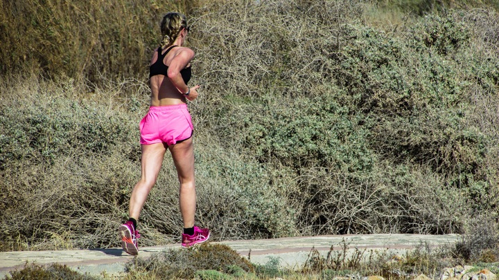 woman running outside on a trail